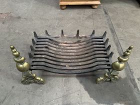 Cast iron fire grate supported on cast brass fire dogs