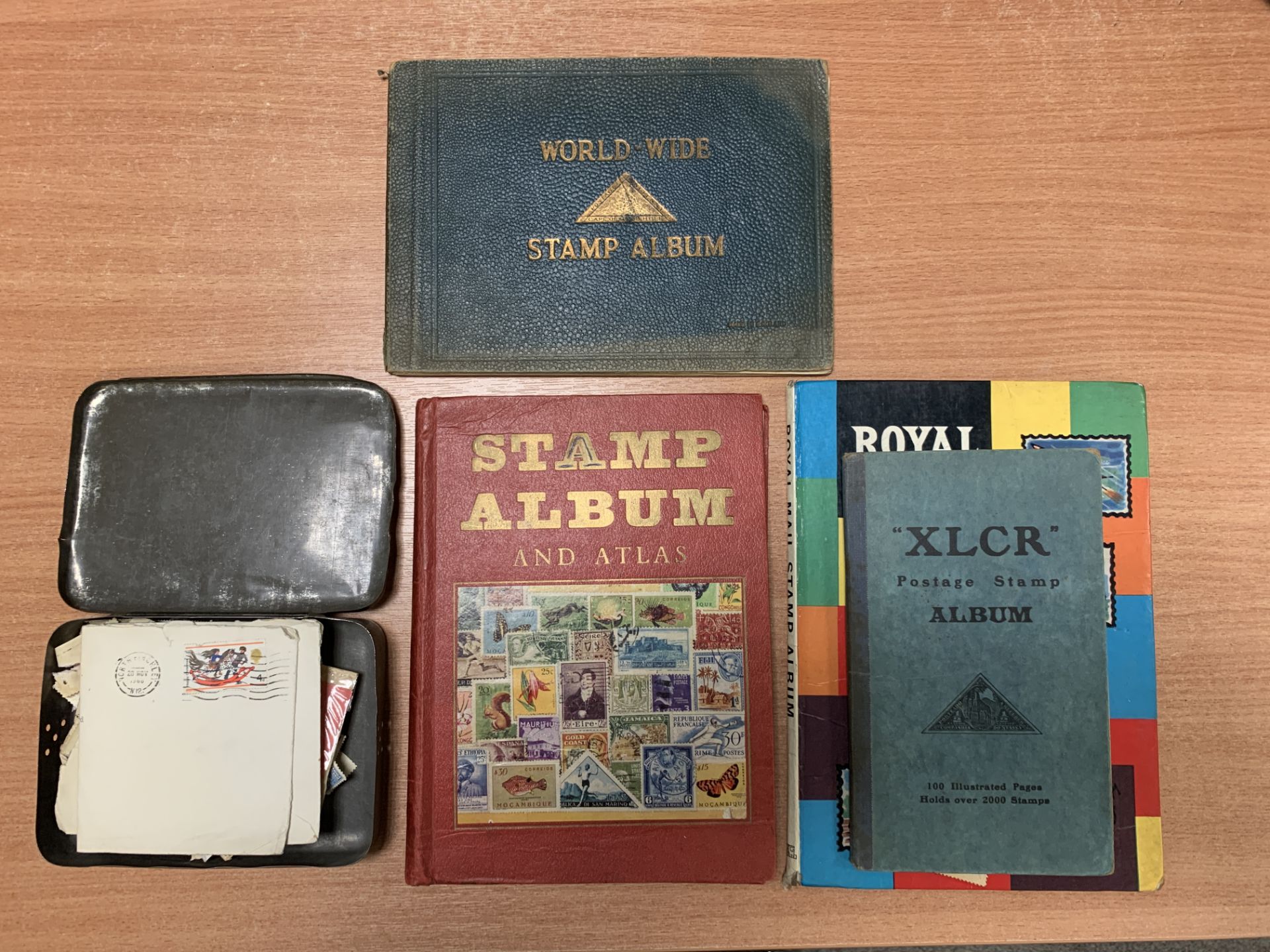A Collection of Various Stamps in Albums and Tin