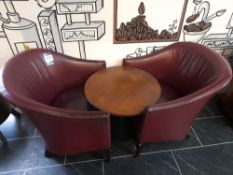2 x Claret leather tub chairs with circular low level table
