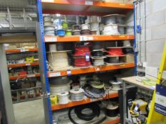 Large quantity of assorted cabling and ducting and bay of stores racking