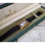 A Gucci lady's goldplated tonneau watch, model no. 2600m, silver dial, black chapter ring Roman
