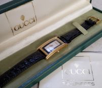 A Gucci lady's goldplated tonneau watch, model no. 2600m, silver dial, black chapter ring Roman