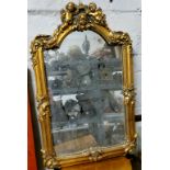 A decorative country house hall mirror / looking glass, surmounted with putti holding a crown with