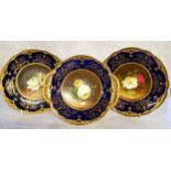 Three Coalport cabinet plates by Fred Howard, painted with panels of cabbage roses set against mossy