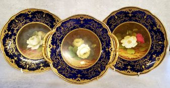 Three Coalport cabinet plates by Fred Howard, painted with panels of cabbage roses set against mossy