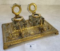 A late 19th century desk top two ink bottle and pen stand deocrated in relief swags & flowers, a