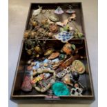 A Japanese black lacquer box the cover decorated with a village scene containing various