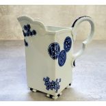 A Royal Worcester Aesthetic Movement square-section cream jug, gros bleu scroll handle, inverted