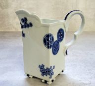 A Royal Worcester Aesthetic Movement square-section cream jug, gros bleu scroll handle, inverted