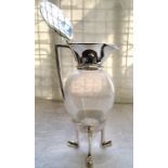 A silver plated mounted glass claret jug after a Design By Christopher Dresser, hinged cover the