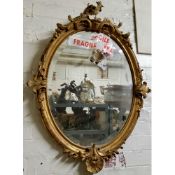 A 19th century Roccoco style looking glass, heavily distressed gesso frame (AF)