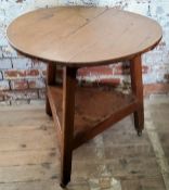 A period English oak cricket table, planked oak and wooden dowel construction, raised on castors,