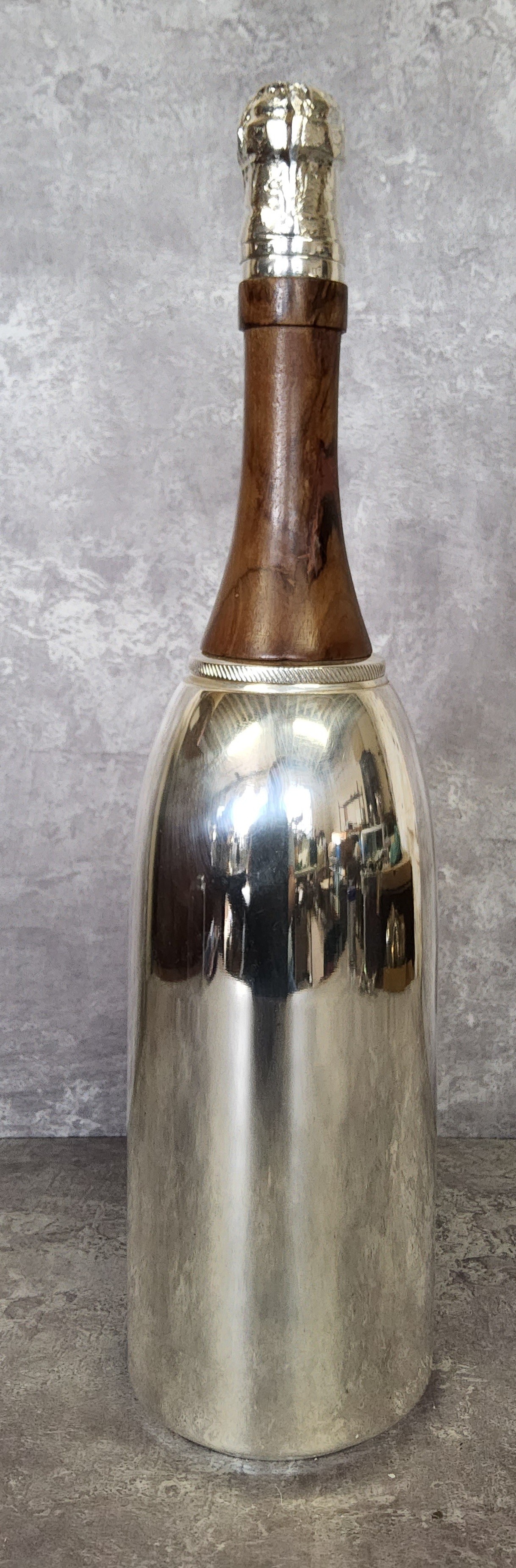 A silver plated and wood novelty cocktail shaker in the form of a champagne bottle stamped to base