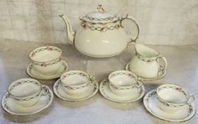 A 1920's Royal Crown Derby part tea service for four, handpainted  with a green ribbon & pink bow