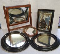 A Regency freestanding dressing table mirror; a pair of 19th century oval ebonised mirrors; a