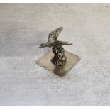 A Dutch silver model of a duck in flight over a tree stump, stamped XXX, 22.89g