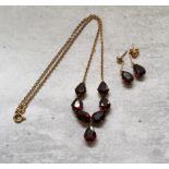 An 18ct gold & garnet drop necklace, mounted with seven Pear shaped garnets, stamped 750; a pair
