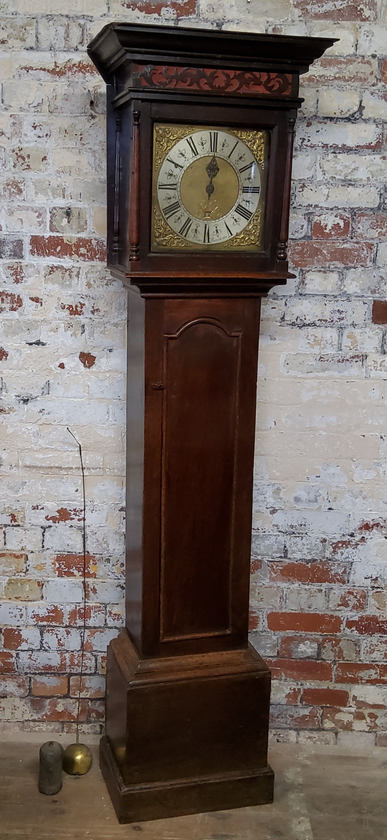 A George III English oak longcase clock, the oversailing ogee hood with decorative fretwork details,