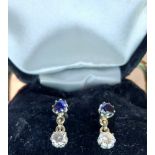A pair of sapphire & diamond drop earrings the claw set stones mounted in white metal