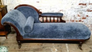 A Victorian mahogany chaise lounge, clean Royal blue upholstery, raised on reeded column legs,