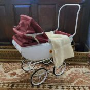 A Tri-ang childs sprung pram, white with burgandy cover c.1950s