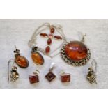 An Indian 925 silver circular pendant set with a central amber cabochon (2.5cms); a pair of oval
