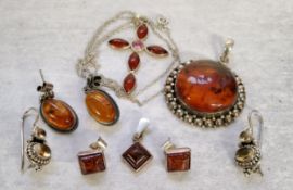 An Indian 925 silver circular pendant set with a central amber cabochon (2.5cms); a pair of oval