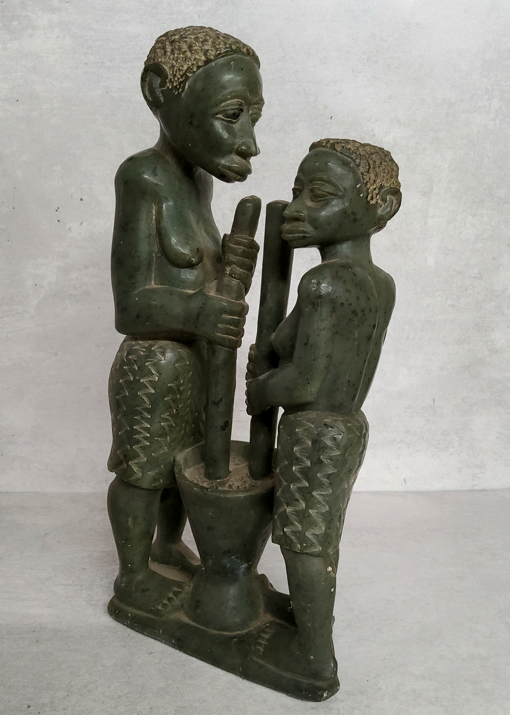Lazarus Tandi, Zimbabwe, African 20th century. A verdite stone carved sculpture grinding sorghum.
