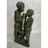 Lazarus Tandi, Zimbabwe, African 20th century. A verdite stone carved sculpture grinding sorghum.