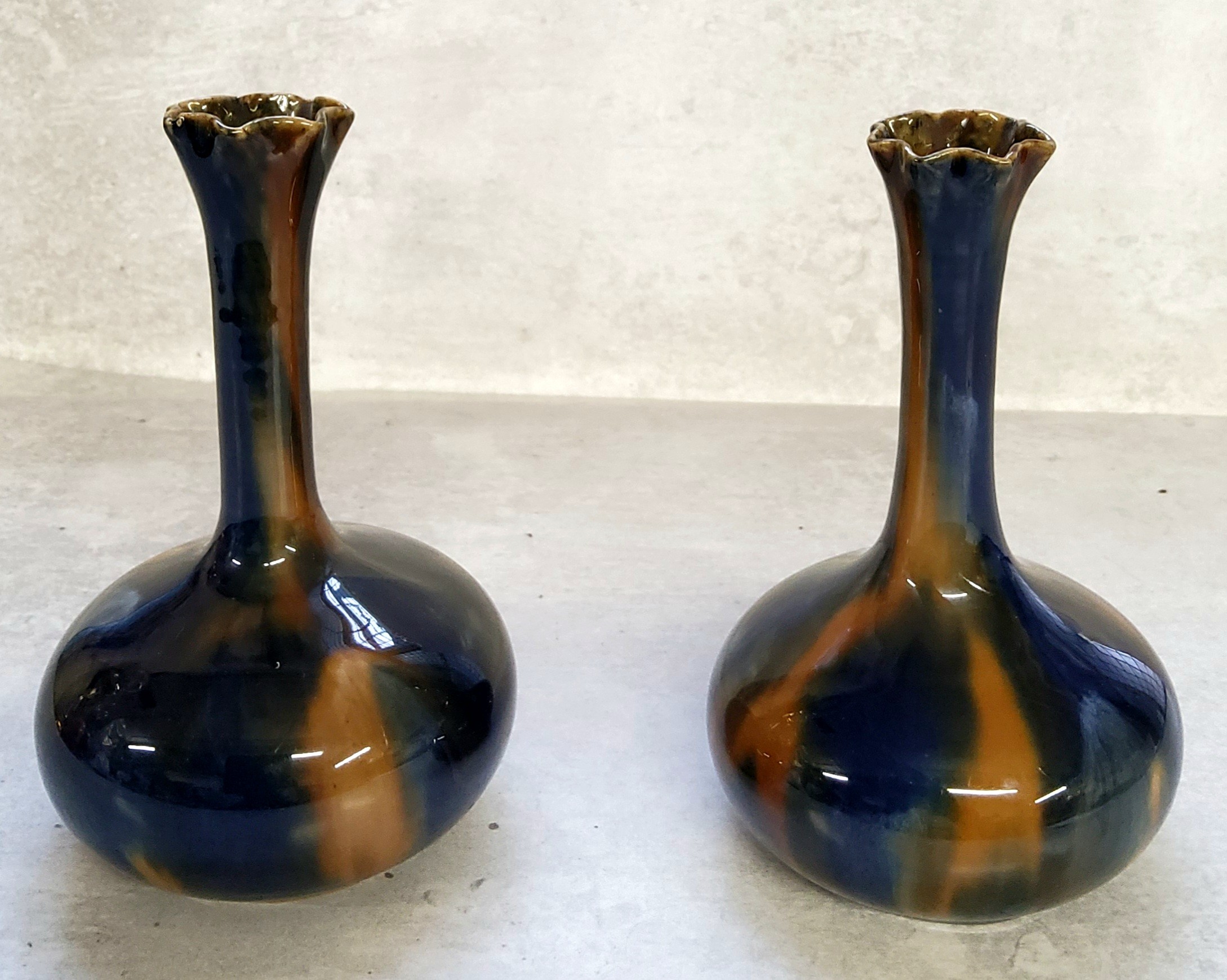 A pair of Art Nouveau globe & stem spilll vases, drip glazed in colbalt blue & ochre 15cms high (2)