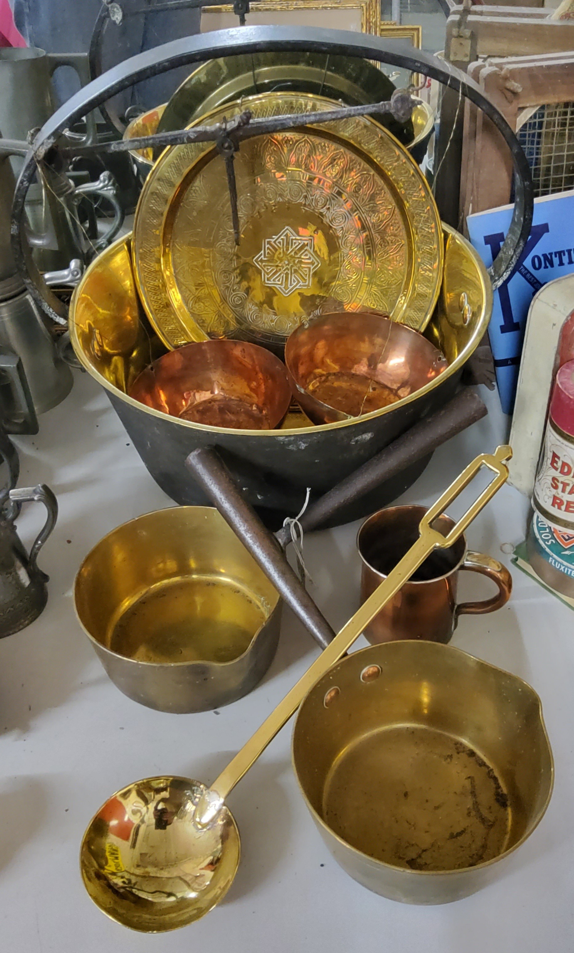 A Victorian highly polished brass jam pan; brass & steel saucepans; a Georgian ladle; Islamic