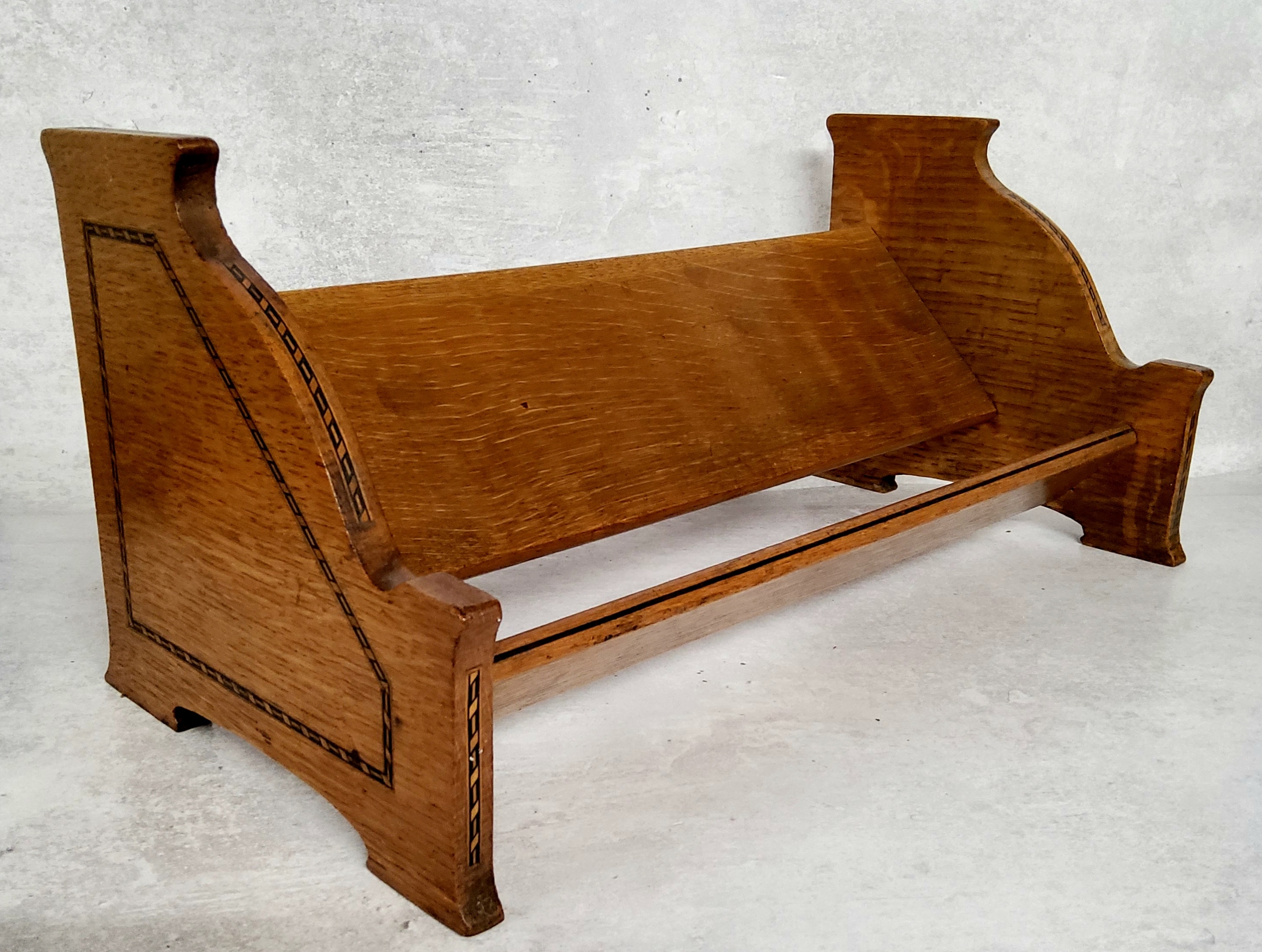 An early 20th century English oak satinwood and ebony inlaid book trough. C.1920. 46cm wide.