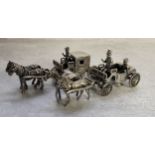 A Dutch silver model of an open topped horse drawn carriage with driver & passenger, stamped XXX,