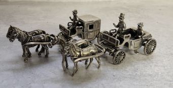 A Dutch silver model of an open topped horse drawn carriage with driver & passenger, stamped XXX,