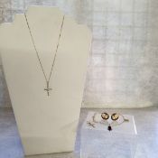 A 14ct gold cross set with ten round white stones; a pair of 9ct gold mounted cameo earrings; a