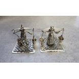 A Dutch silver figures of a male & female milk carrier in traditional dress on a base decorated in