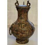 Chinese bronze archaic style temple vase with loop handles, the body engraved throughout with script
