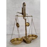 A late Victorian brass double beam weighing scales base holding 8 weights, (AF) 39cm heigh x 30cm