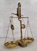 A late Victorian brass double beam weighing scales base holding 8 weights, (AF) 39cm heigh x 30cm