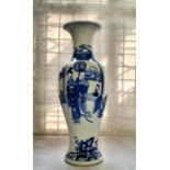 A Chinese Kangxi period baluster shaped porcelain vase, decorated in underglazed blue with a servant