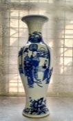 A Chinese Kangxi period baluster shaped porcelain vase, decorated in underglazed blue with a servant