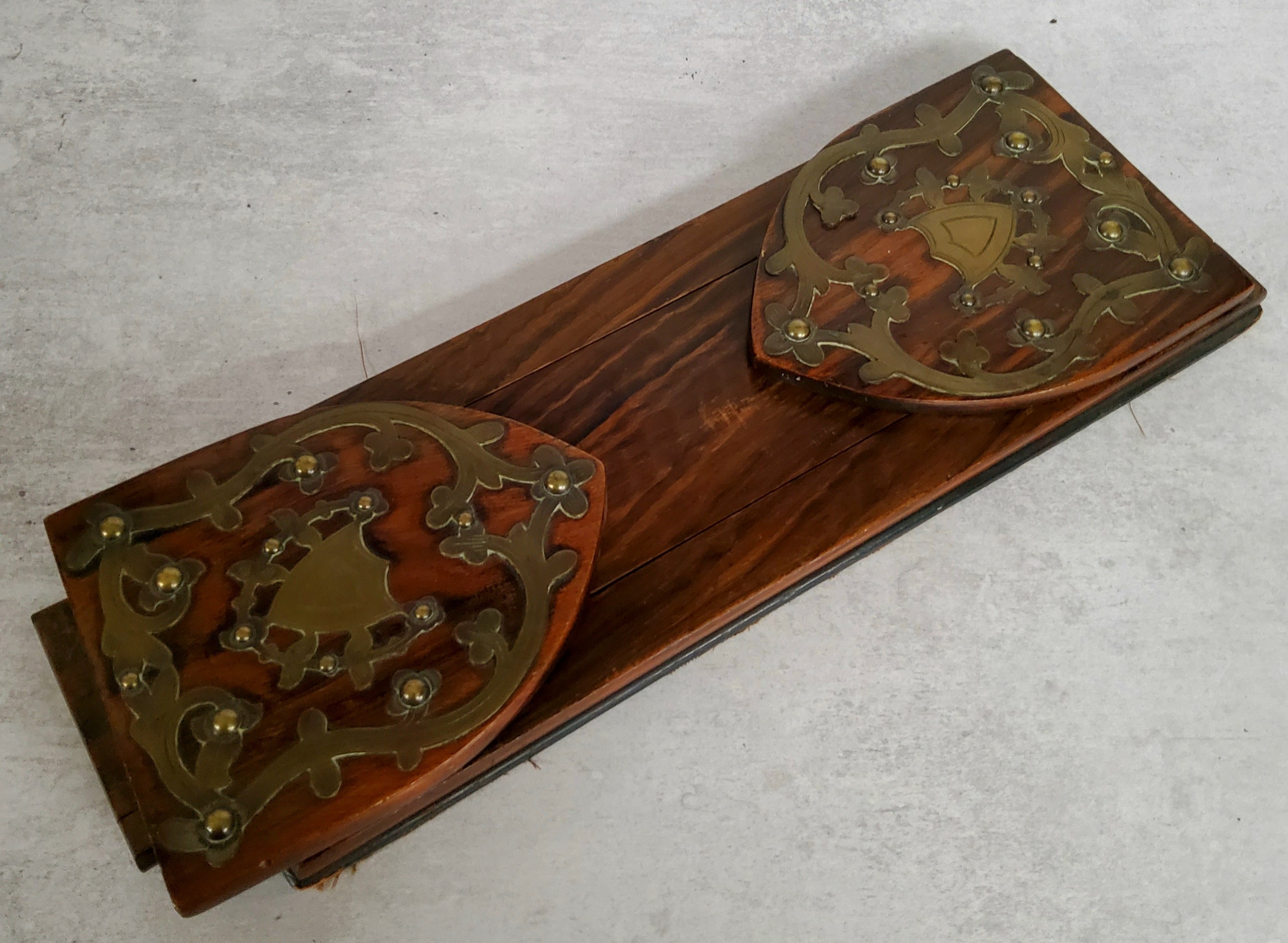 A Victorian coromandel and brass extending book trough, c.1860, vacant cartouche. Measures 33cm