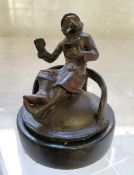 A novelty cold painted bronze paperweight of a seated anthropomorphic monkey in a smoking jacket &