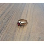 A early 20th century 9ct rose gold gypsy ring, centrally set with round round red stone, size M, 4.