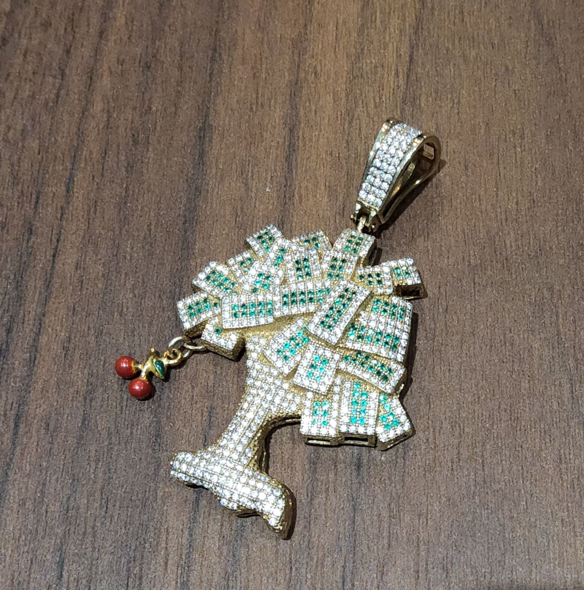 An unusual 9ct gold pendant in the form of a money tree, set with white stones and emeralds 6.