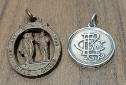 A silver winners medal, the obverse cast in relief with a monogram ECR, the reverse cast in relief