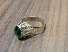 A vintage 9ct gold dress ring. set with an oval green stone, pierce worked shoulders, London,