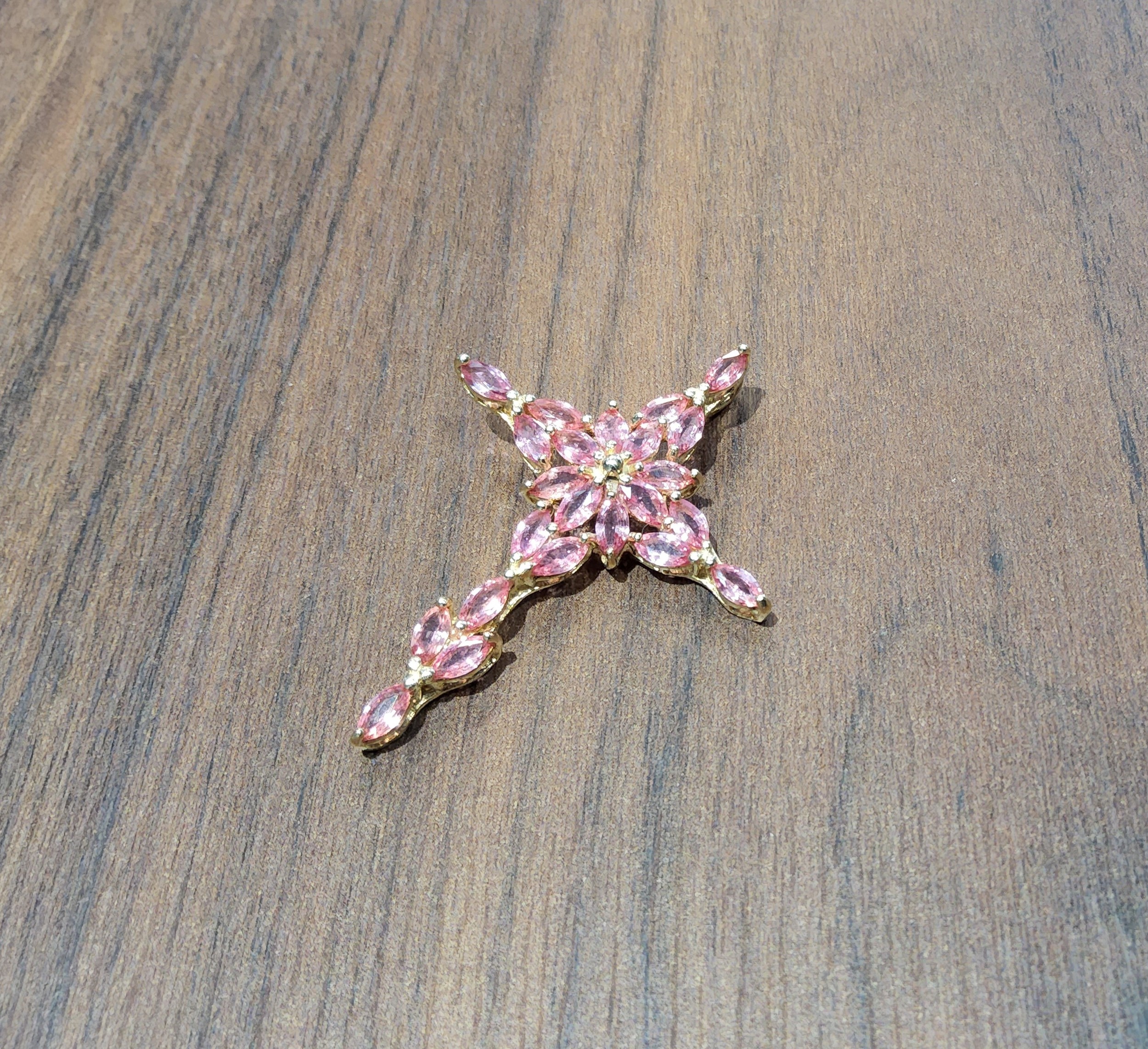 An 18ct gold cross, claw set with twenty three marquise pink topazes, DK, Birmingham, 2006 7.8g