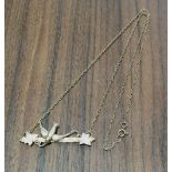 A 9ct gold pendant necklace, the pendant bar mounted with a swallow and foilage, belcher chain 2.85g