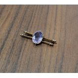 A 9ct gold two bar brooch, centrally set with an oval amethyst (16 x 12mm), stamped 9ct, 4.1g gross